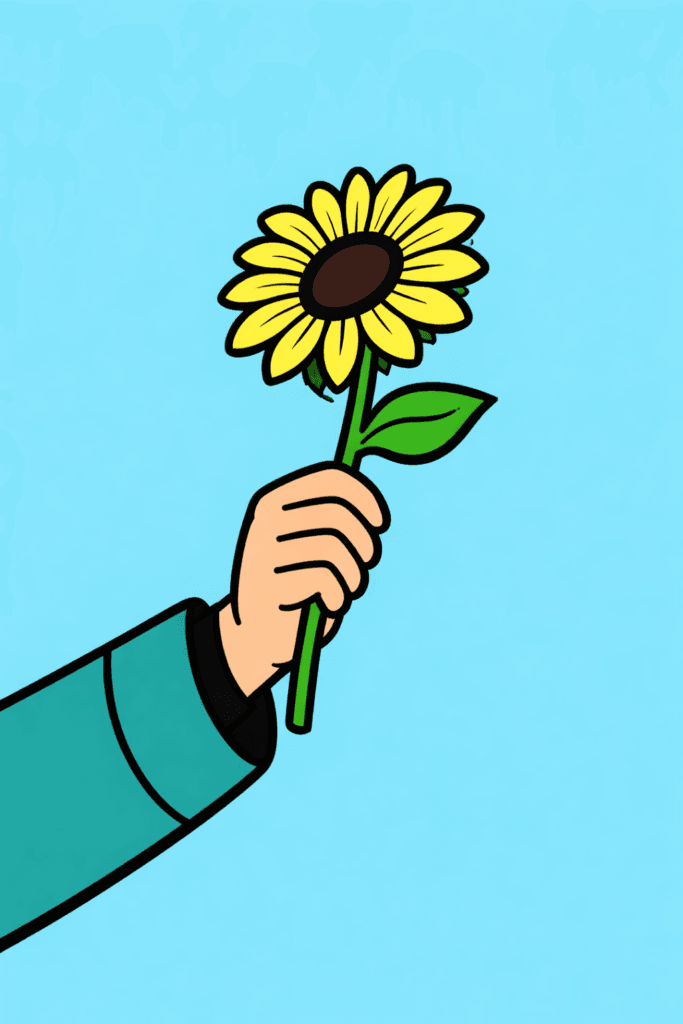 Hand holding a sunflower against blue